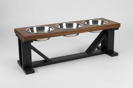 Wooden pet feeding station with three metal bowls on a white background